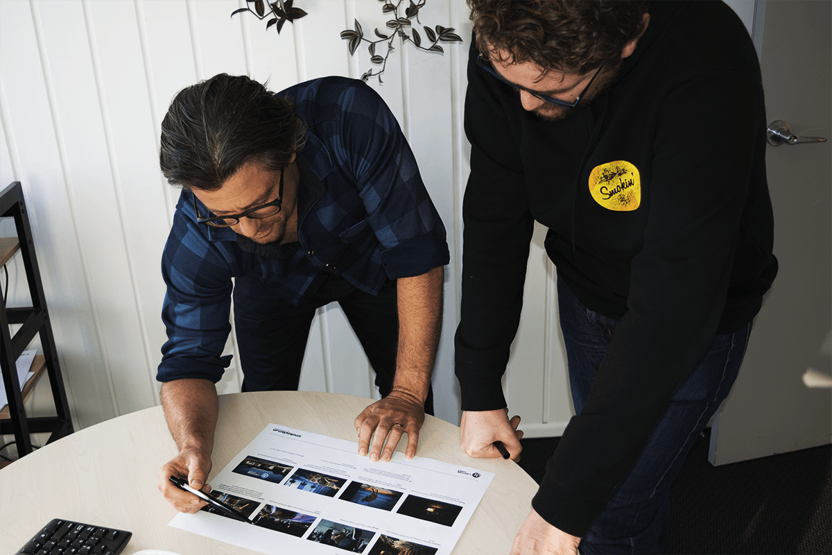 Ross and  Stu looking at a storyboard